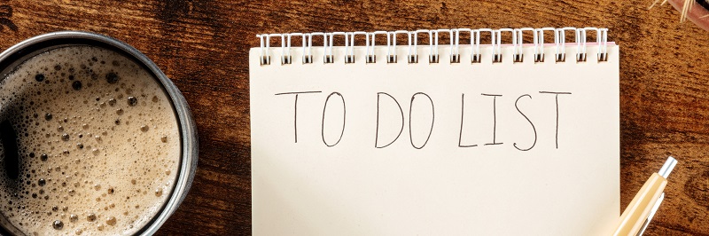 To do list overhead panorama with coffee. A notebook on a wooden desk. The concept of planning, time management, a flat lay